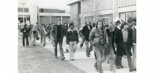 Students walking in front of the library circa 1970-1980.